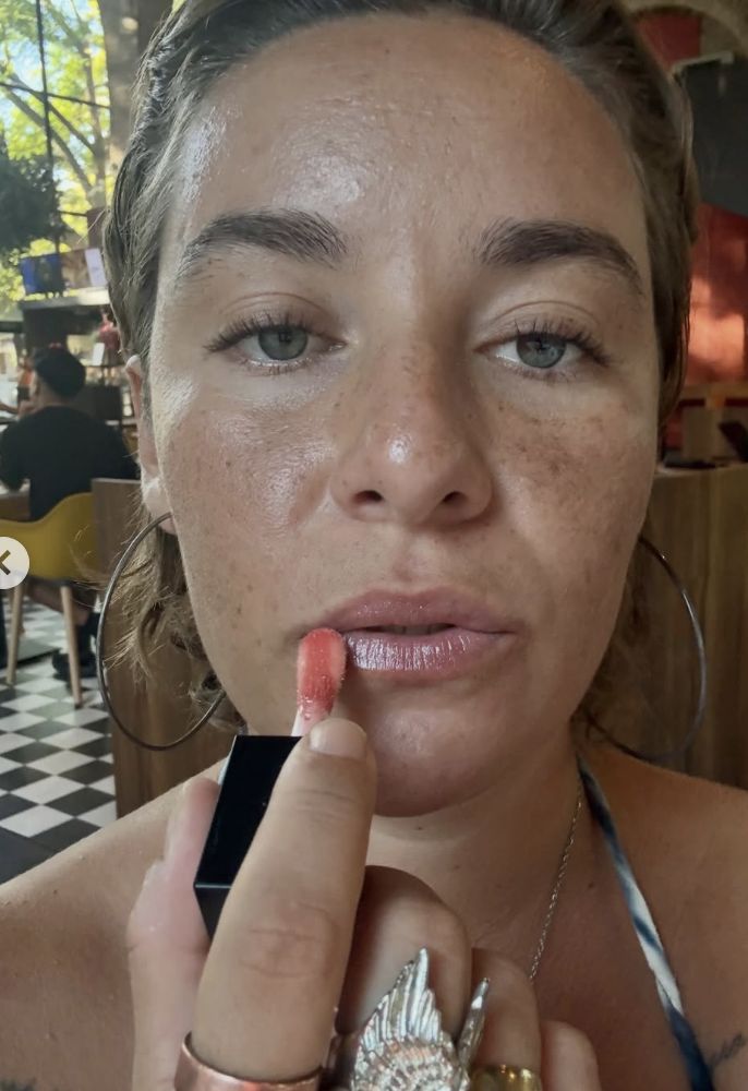 Luisa pintándose los labios, de cerca.